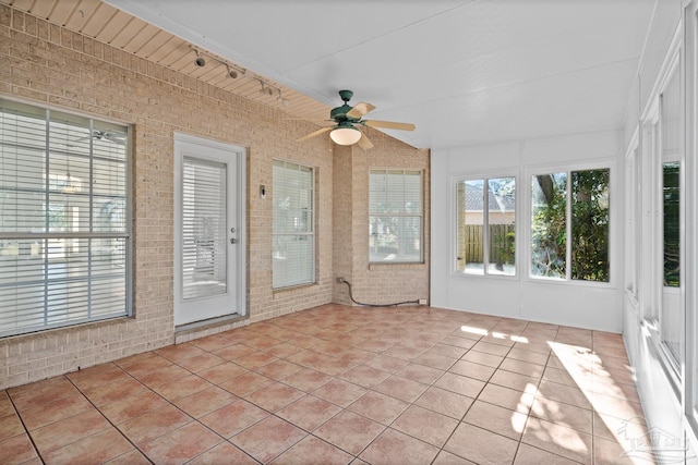 unfurnished sunroom with ceiling fan