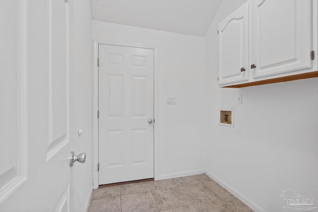 washroom with cabinets, washer hookup, and a textured ceiling