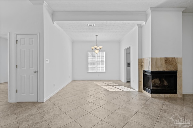 unfurnished living room featuring a tile fireplace, light tile patterned flooring, ornamental molding, and a notable chandelier