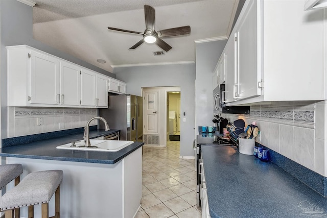 4122 Cobia St, Pensacola, FL 32507 - kitchen featuring a sink, dark countertops, white cabinetry, ceiling fan, and appliances with stainless steel finishes