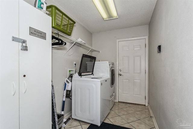 4122 Cobia St, Pensacola, FL 32507 - laundry room with independent washer and dryer, light tile patterned flooring, a textured ceiling, and baseboards