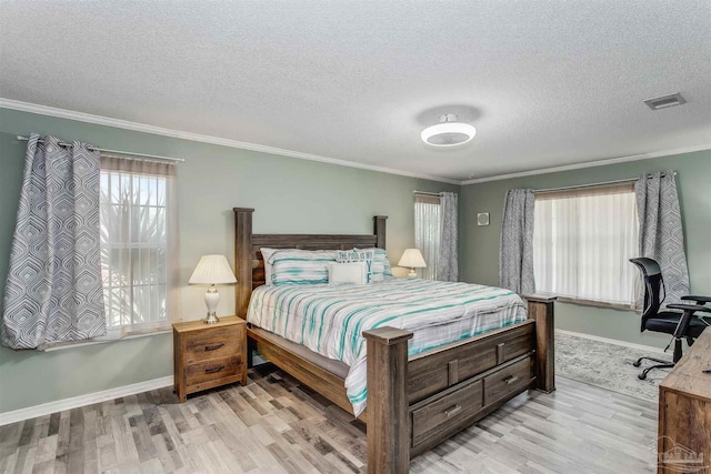 4122 Cobia St, Pensacola, FL 32507 - bedroom featuring wood finished floors, crown molding, a textured ceiling, and baseboards