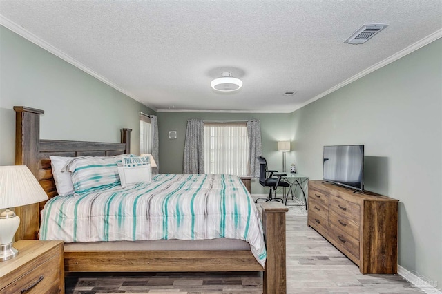 4122 Cobia St, Pensacola, FL 32507 - bedroom featuring light wood-type flooring, crown molding, a textured ceiling, and baseboards