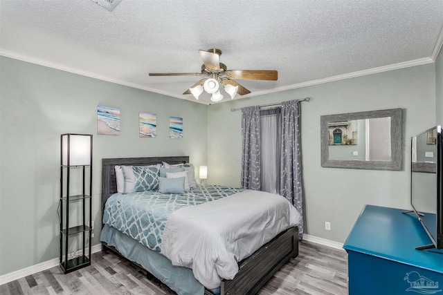4122 Cobia St, Pensacola, FL 32507 - bedroom featuring wood finished floors, crown molding, a textured ceiling, baseboards, and ceiling fan