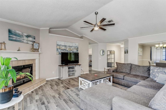 4122 Cobia St, Pensacola, FL 32507 - living room featuring wood finished floors, ceiling fan, lofted ceiling, ornamental molding, and a textured ceiling