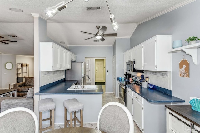 4122 Cobia St, Pensacola, FL 32507 - kitchen featuring appliances with stainless steel finishes, a ceiling fan, dark countertops, ornamental molding, and white cabinets