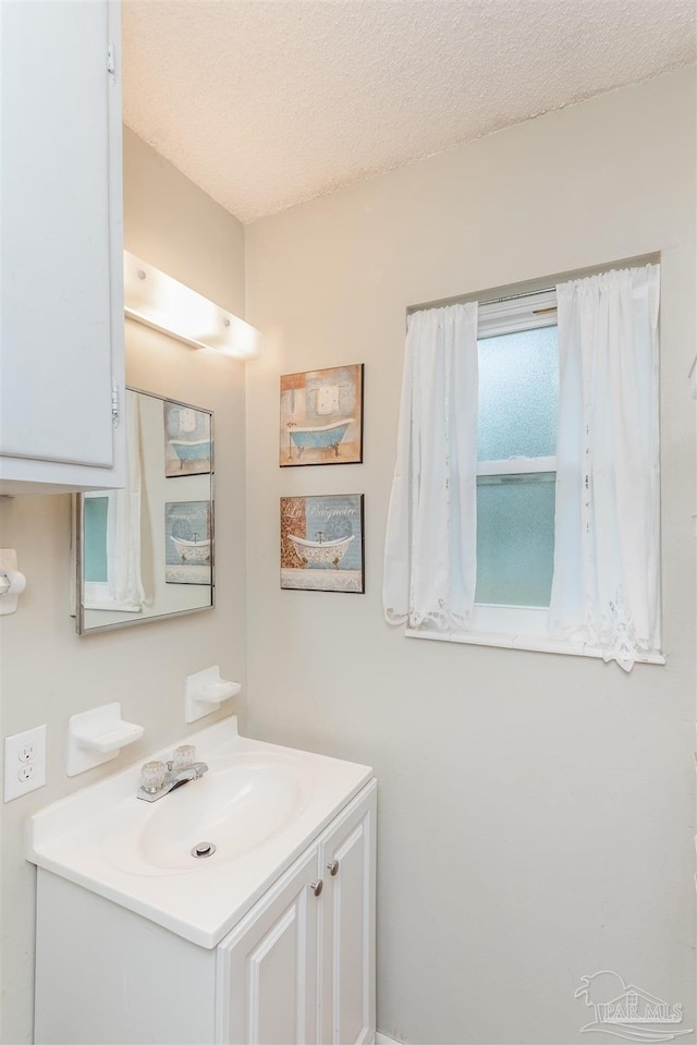 bathroom with a textured ceiling and vanity