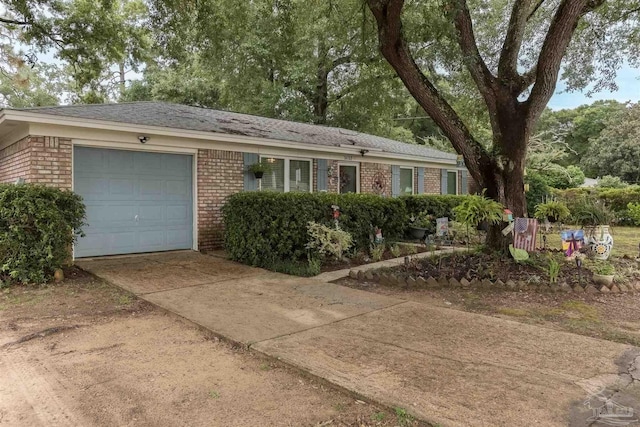 ranch-style house featuring a garage, concrete driveway, and brick siding