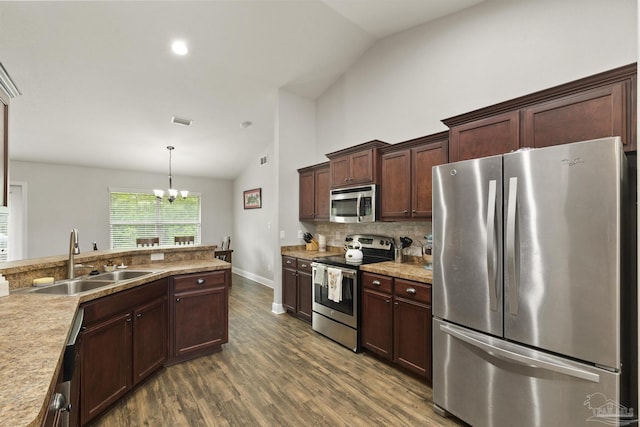 kitchen with dark wood finished floors, an inviting chandelier, appliances with stainless steel finishes, a sink, and visible vents