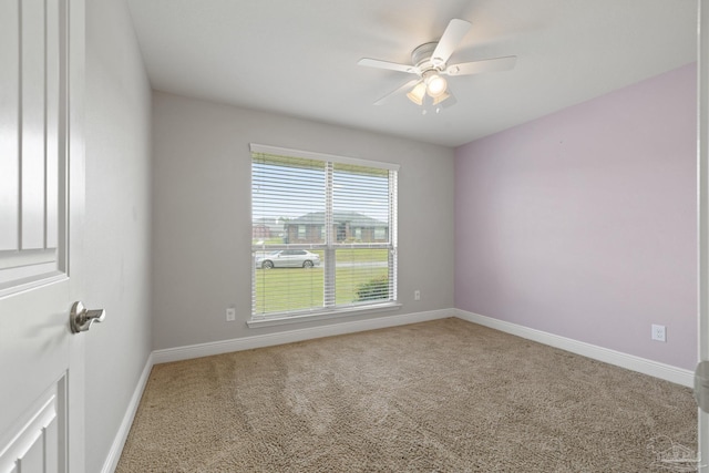 spare room featuring carpet flooring, ceiling fan, and baseboards