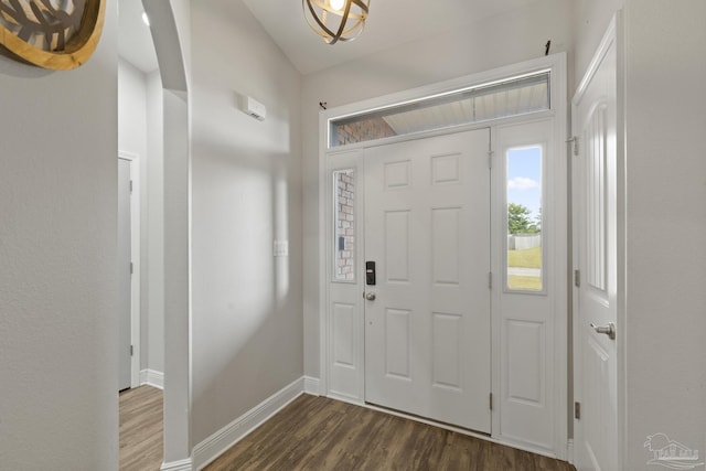 foyer entrance featuring dark wood-style flooring and baseboards