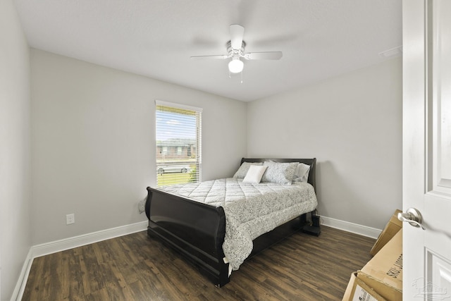 bedroom featuring baseboards, ceiling fan, and dark wood-style flooring