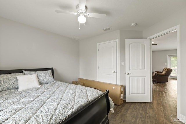 bedroom featuring dark wood finished floors, visible vents, and ceiling fan