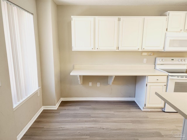 kitchen featuring white cabinetry, white appliances, and light wood-type flooring