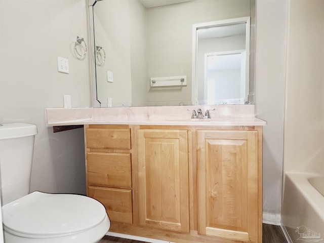 bathroom with vanity, wood-type flooring, and toilet