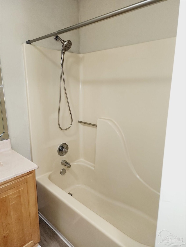 bathroom featuring bathing tub / shower combination and vanity