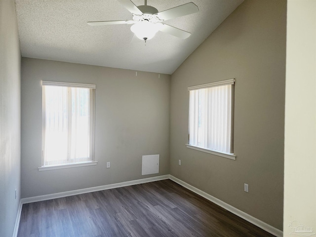 spare room featuring ceiling fan, lofted ceiling, a textured ceiling, and dark hardwood / wood-style flooring