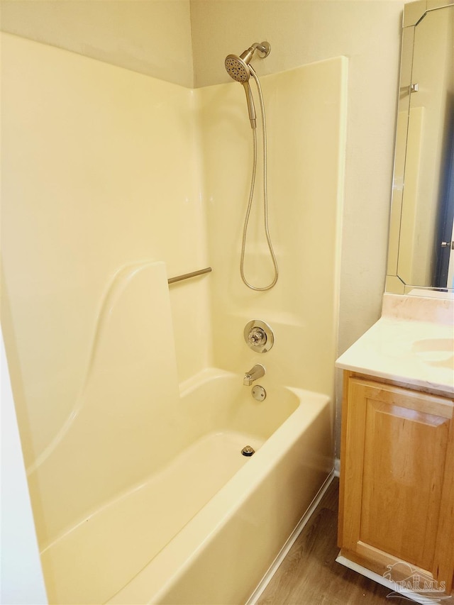 bathroom with vanity, bathtub / shower combination, and hardwood / wood-style floors