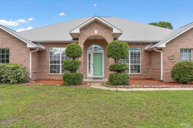 7850 Amethyst Dr, Pensacola, FL 32506 - view of front facade featuring brick siding, a front yard, and a shingled roof