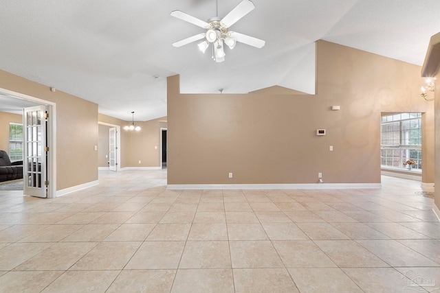 7850 Amethyst Dr, Pensacola, FL 32506 - empty room featuring a chandelier, a ceiling fan, light tile patterned floors, high vaulted ceiling, and baseboards
