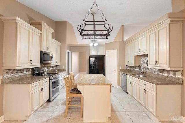 7850 Amethyst Dr, Pensacola, FL 32506 - kitchen with appliances with stainless steel finishes, decorative backsplash, a center island, a sink, and a textured ceiling
