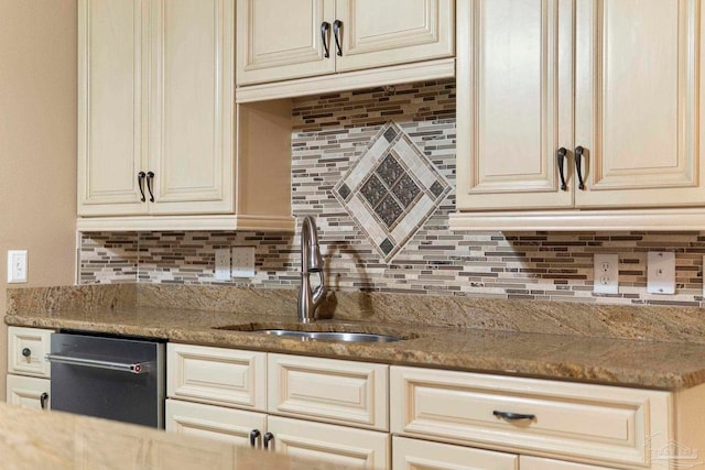 7850 Amethyst Dr, Pensacola, FL 32506 - kitchen with a sink, cream cabinetry, dishwasher, tasteful backsplash, and light stone countertops