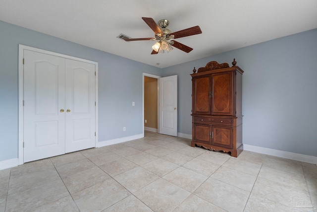 7850 Amethyst Dr, Pensacola, FL 32506 - unfurnished bedroom featuring a closet, baseboards, a ceiling fan, and light tile patterned flooring