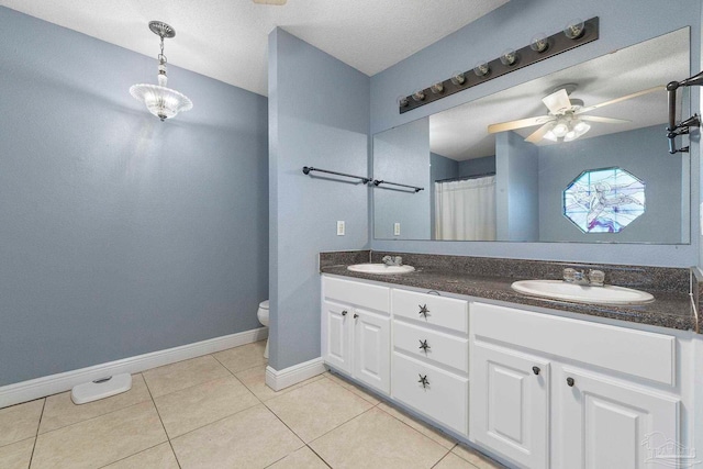 7850 Amethyst Dr, Pensacola, FL 32506 - bathroom with baseboards, tile patterned floors, double vanity, toilet, and ceiling fan