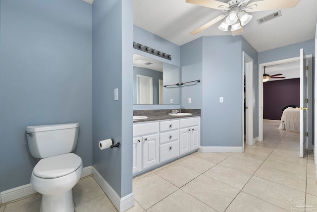 7850 Amethyst Dr, Pensacola, FL 32506 - bathroom with a ceiling fan, connected bathroom, toilet, double vanity, and tile patterned flooring