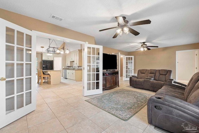 7850 Amethyst Dr, Pensacola, FL 32506 - living area featuring french doors, light tile patterned floors, ceiling fan, and a chandelier