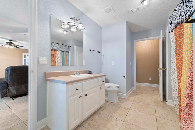 7850 Amethyst Dr, Pensacola, FL 32506 - bathroom with ceiling fan, a textured ceiling, vanity, toilet, and tile patterned flooring