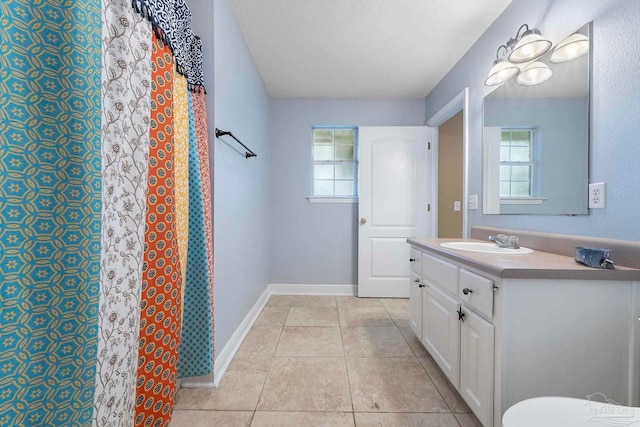 7850 Amethyst Dr, Pensacola, FL 32506 - full bath featuring plenty of natural light, tile patterned flooring, vanity, baseboards, and a textured ceiling