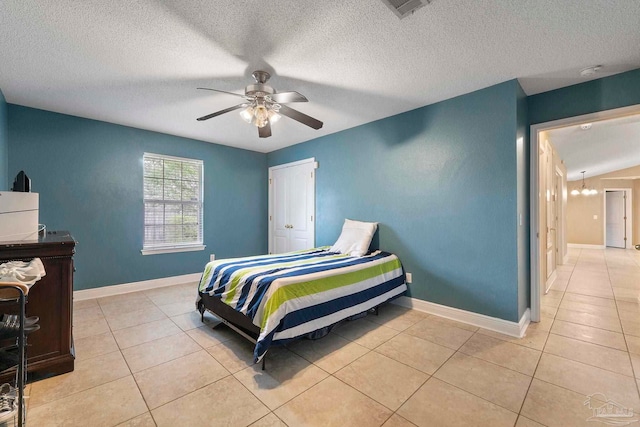 7850 Amethyst Dr, Pensacola, FL 32506 - bedroom featuring light tile patterned floors, ceiling fan, baseboards, and a textured ceiling