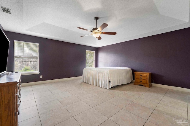 7850 Amethyst Dr, Pensacola, FL 32506 - bedroom featuring multiple windows, light tile patterned flooring, a ceiling fan, and a textured ceiling