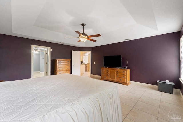 7850 Amethyst Dr, Pensacola, FL 32506 - bedroom featuring a tray ceiling, light tile patterned floors, baseboards, a ceiling fan, and connected bathroom