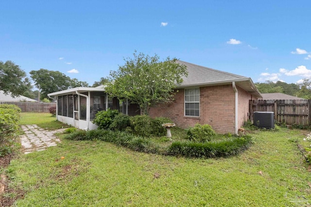 7850 Amethyst Dr, Pensacola, FL 32506 - back of house with a sunroom, central AC, brick siding, and a shingled roof