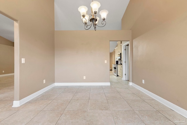7850 Amethyst Dr, Pensacola, FL 32506 - spare room featuring a chandelier, light tile patterned floors, baseboards, and vaulted ceiling