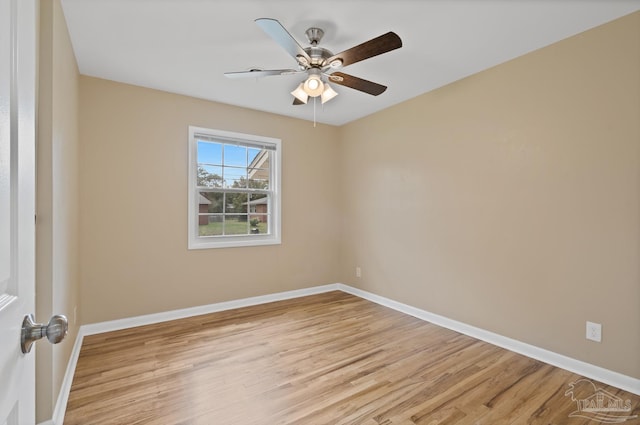 unfurnished room with a ceiling fan, light wood-type flooring, and baseboards