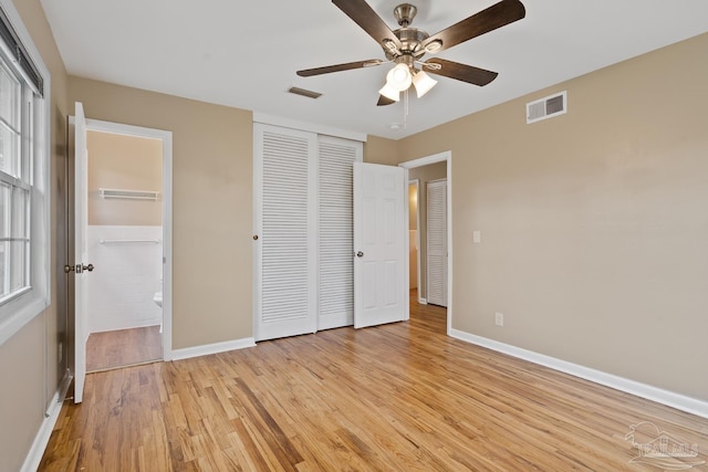 unfurnished bedroom featuring baseboards, visible vents, and light wood finished floors