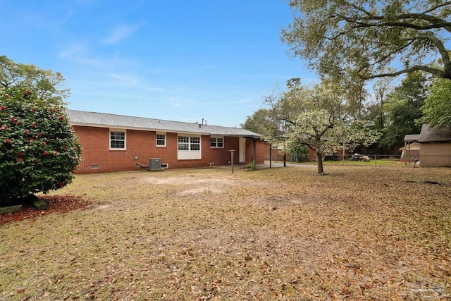 view of yard with central AC and fence