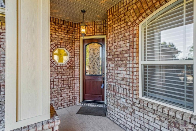 view of exterior entry with covered porch