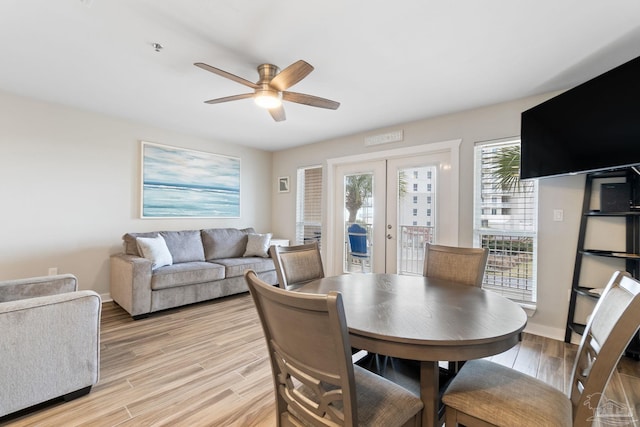 dining area with french doors, ceiling fan, and light hardwood / wood-style floors