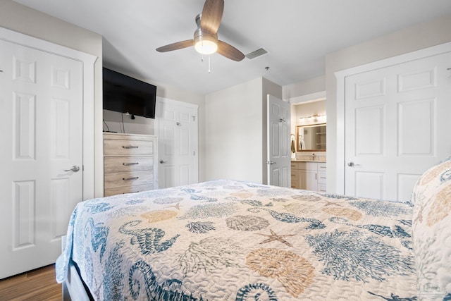 bedroom with ceiling fan, hardwood / wood-style floors, and ensuite bath