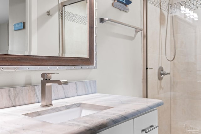 bathroom with vanity and a shower with shower door