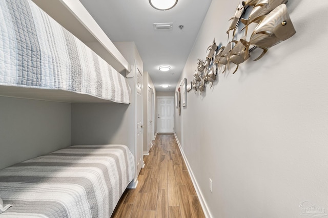 hallway with hardwood / wood-style floors