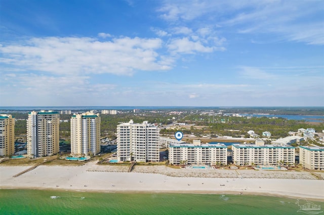 bird's eye view with a water view and a beach view