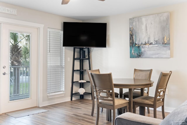 dining room with wood-type flooring, a wealth of natural light, and ceiling fan