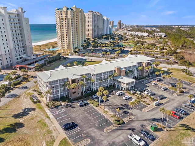 drone / aerial view featuring a water view and a view of the beach