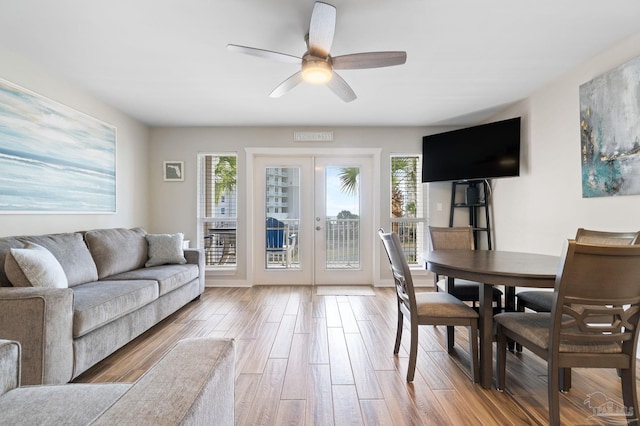 living room with hardwood / wood-style flooring, ceiling fan, and french doors