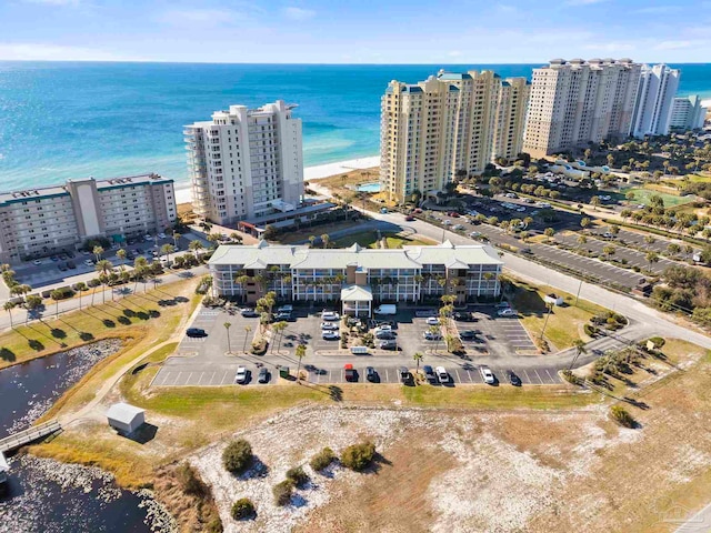 birds eye view of property featuring a water view and a beach view